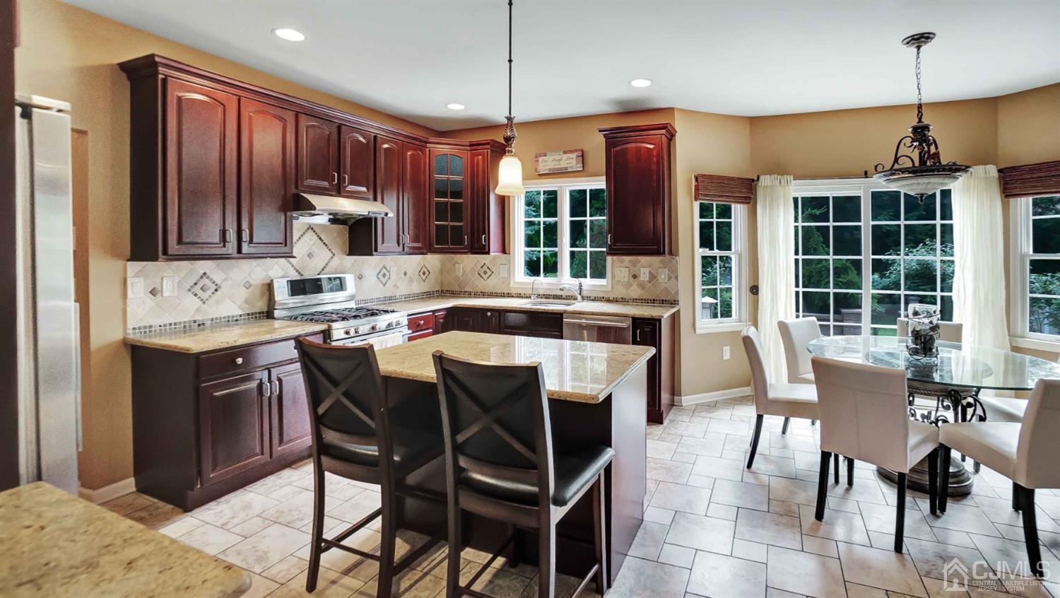 7 Homestead Road Edison, NJ 08820 - Photo 14 of 68 a dining table with chairs and kitchen view