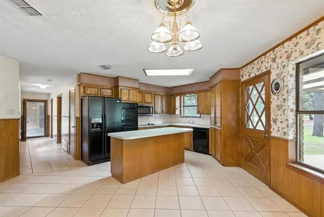 a large kitchen with cabinets and stainless steel appliances