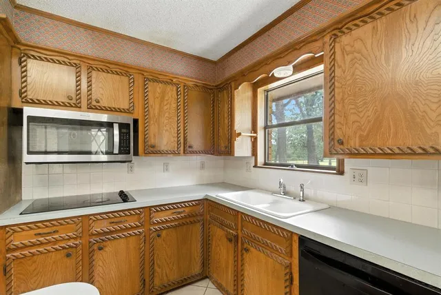 a kitchen with a sink and a window