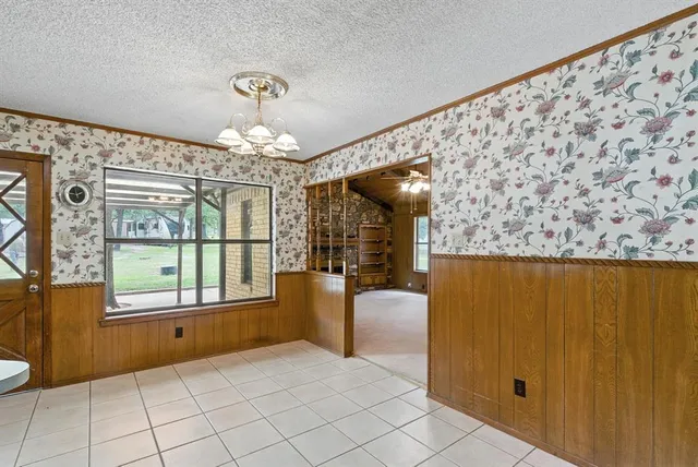 a very nice looking room with a large window and chandelier