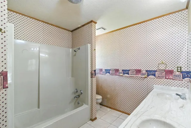 a bathroom with a bathtub and shower
