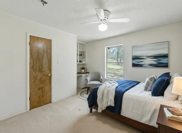 a bedroom with a bed and a painting on the wall