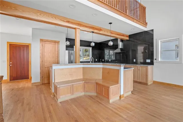 a view of a kitchen with cabinets and wooden floor