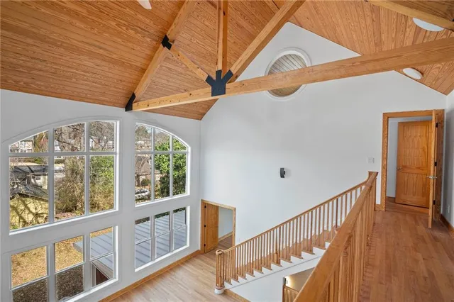 a view of empty room with window and wooden floor