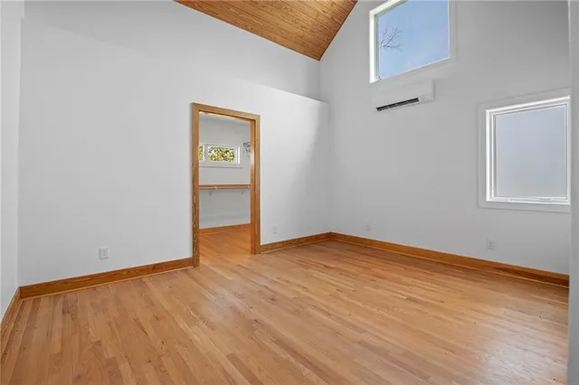 a view of a room with wooden floor and a large window