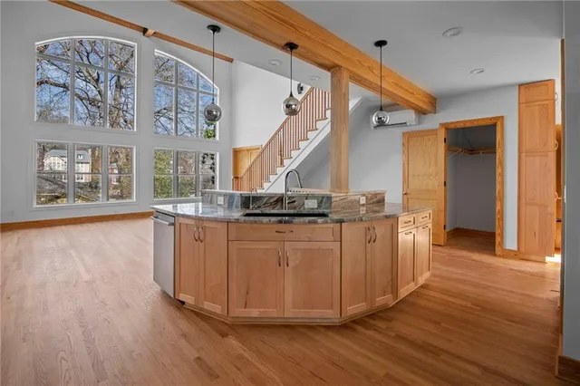 a view of a living room and kitchen with wooden floor