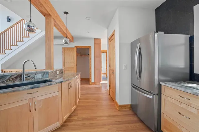a kitchen with stainless steel appliances a refrigerator and a sink
