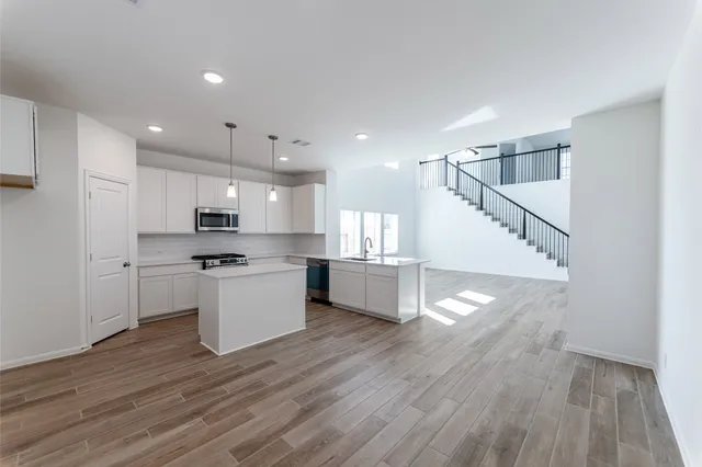 a kitchen with stainless steel appliances a refrigerator sink and cabinets
