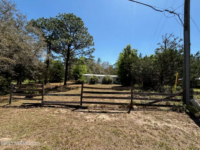 a view of park with wooden fence