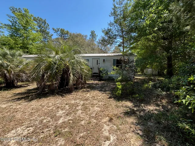 a view of house with trees in the background
