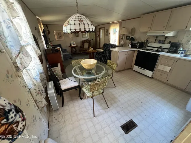 a kitchen with a sink a stove and cabinets
