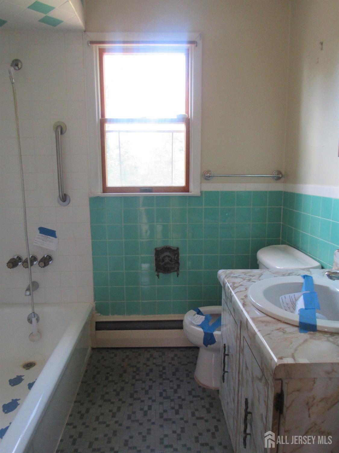206 Overbrook Road Piscataway, NJ 08854 - Photo 17 of 34 a bathroom with a sink toilet and window