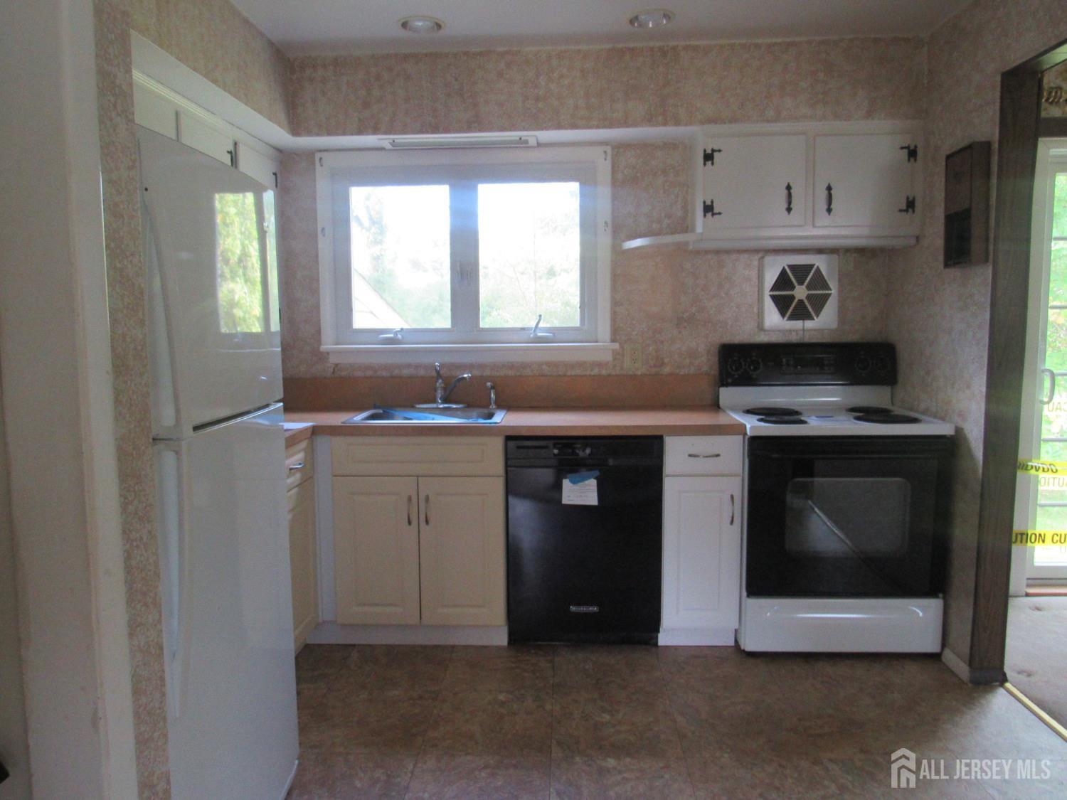 206 Overbrook Road Piscataway, NJ 08854 - Photo 21 of 34 a kitchen with cabinets appliances and a window