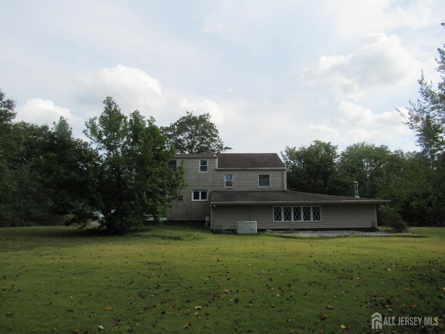 206 Overbrook Road Piscataway, NJ 08854 - Photo 4 of 34 a view of a big house with a big yard and large trees