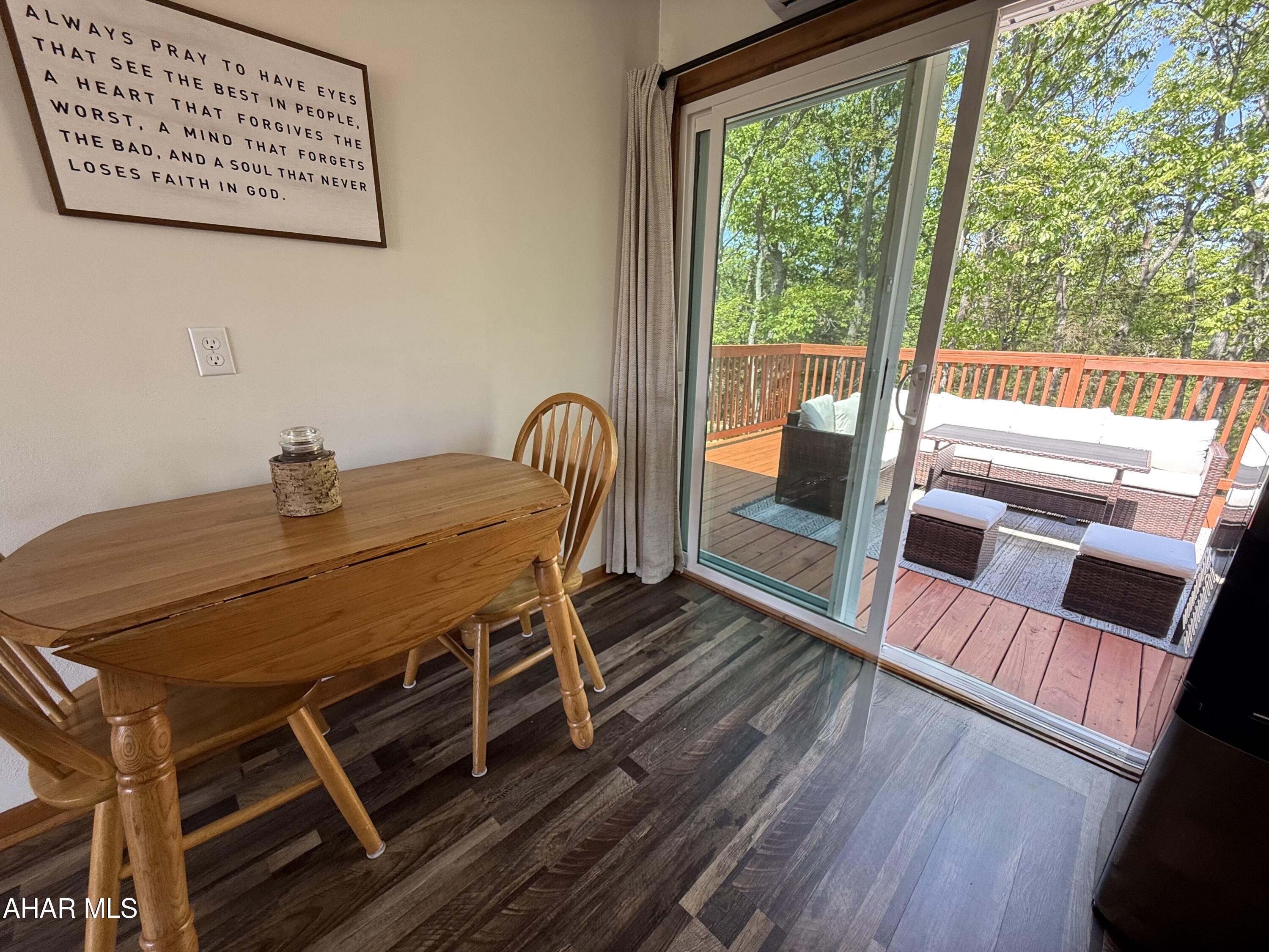 473 Calhoun Road Everett, PA 15537 - Photo 16 of 45 a view of a dining room with furniture wooden floor and front door