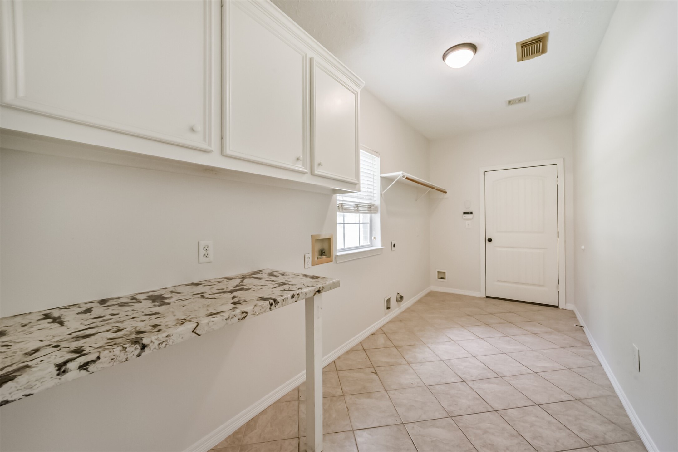 27322 Afton Way Huffman, TX 77336 - Photo 34 of 50 Oversized utility room includes extensive storage cabinetry, folding counter space, and room for additional organization.