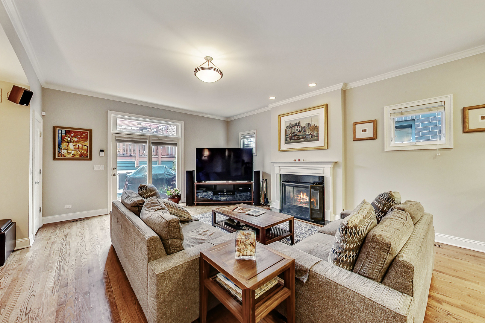 1508 West School Street Chicago, IL 60657 - Photo 11 of 40 a living room with furniture a fireplace and a flat screen tv