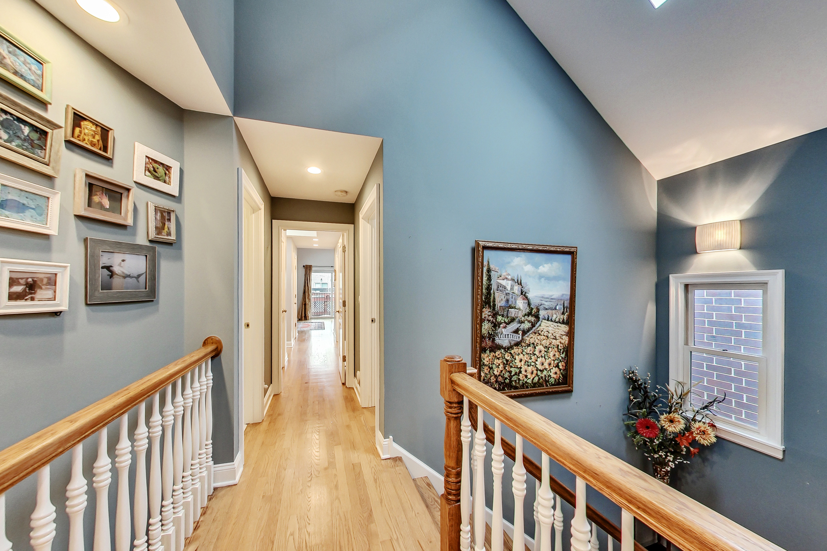 1508 West School Street Chicago, IL 60657 - Photo 13 of 40 a view of a hallway to a room with wooden floor and stairs