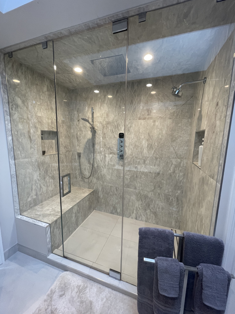 1508 West School Street Chicago, IL 60657 - Photo 17 of 40 a bathroom with a glass shower door