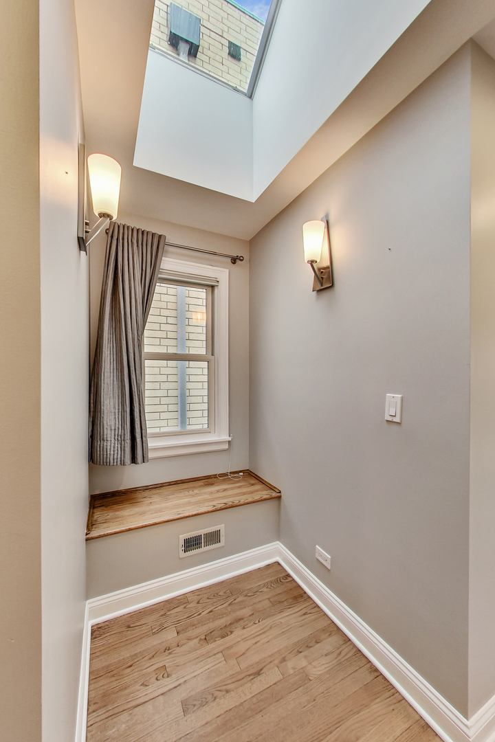 1508 West School Street Chicago, IL 60657 - Photo 19 of 40 a view of empty room with wooden floor and fan