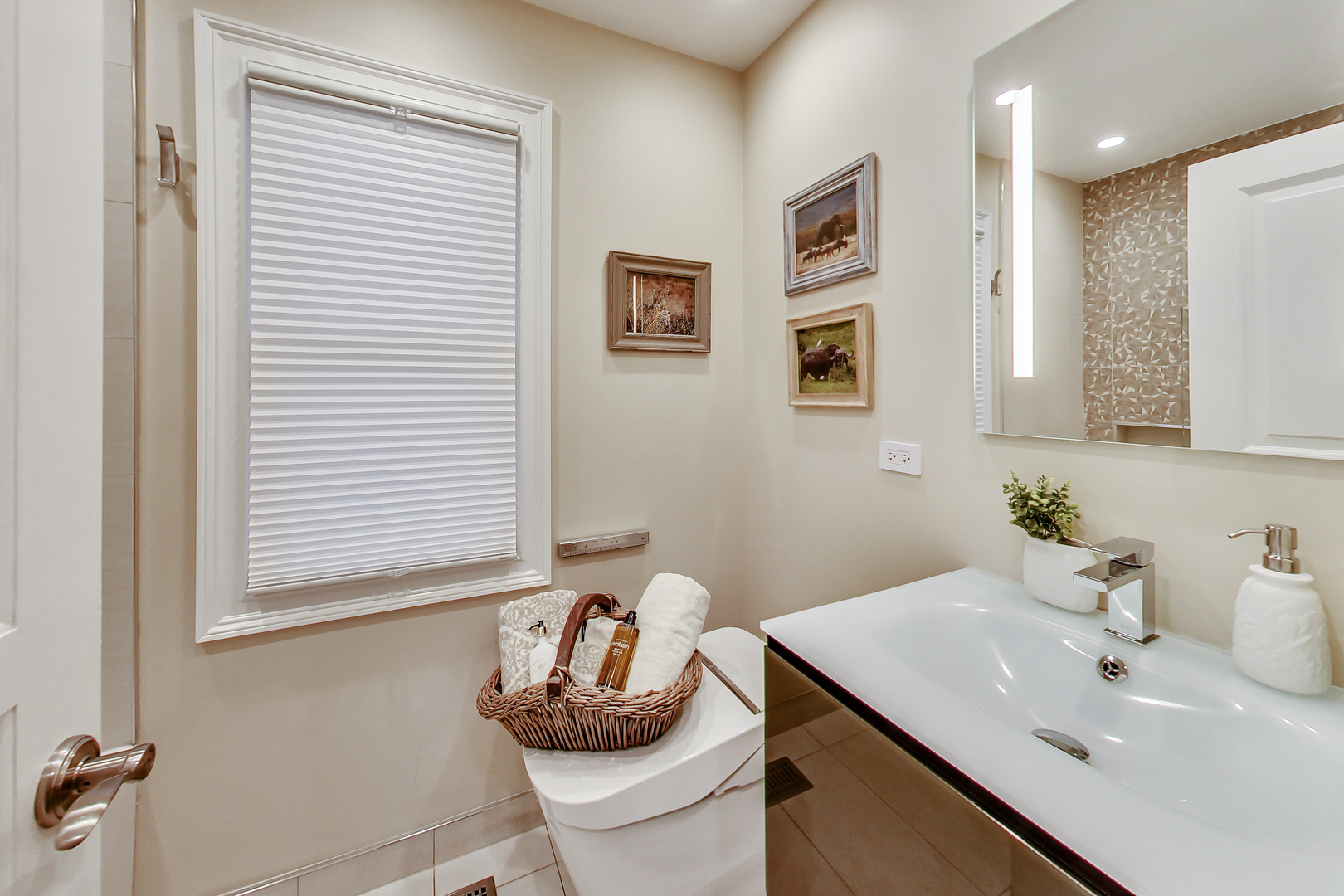 1508 West School Street Chicago, IL 60657 - Photo 23 of 40 a bathroom with a sink and a mirror