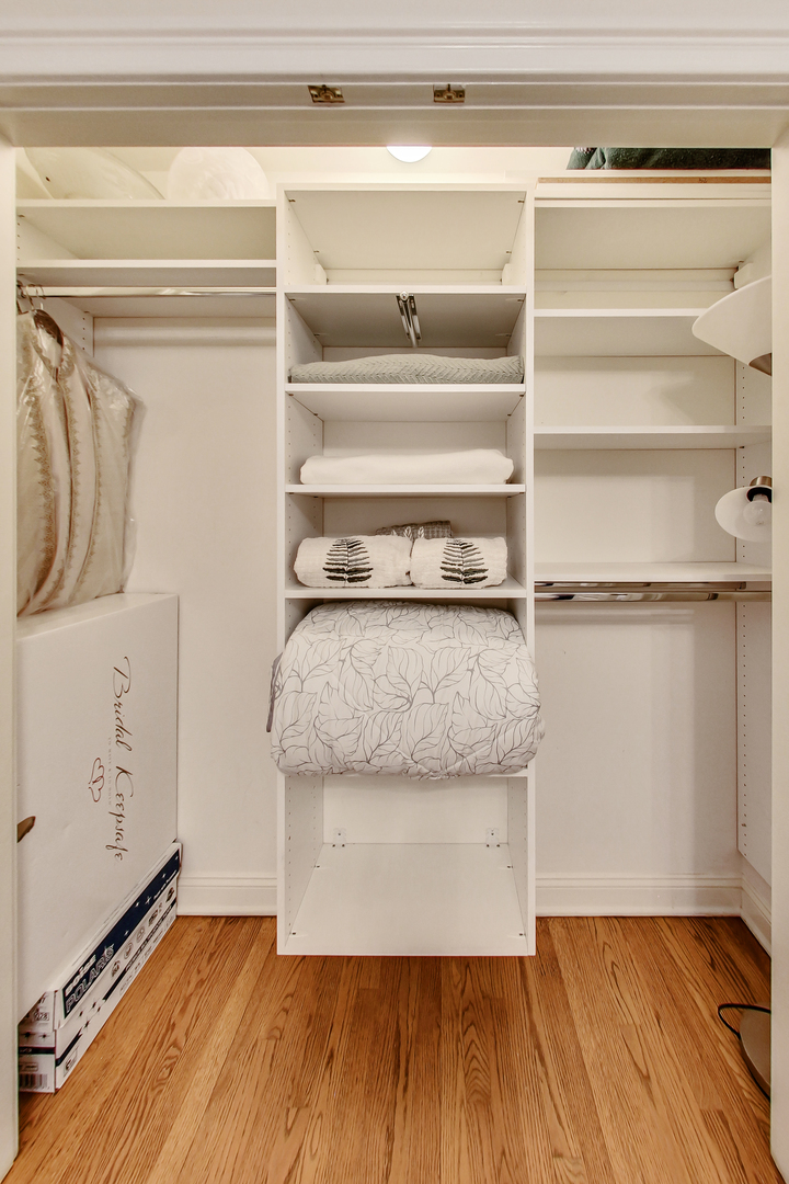 1508 West School Street Chicago, IL 60657 - Photo 28 of 40 a view of walk in closet with clothes and shoes