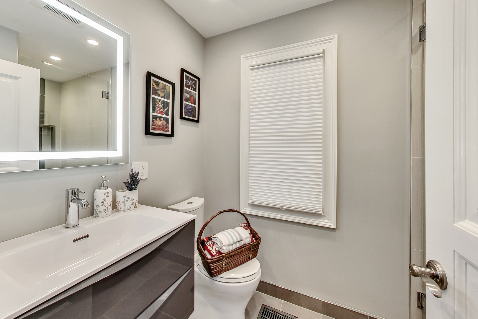 1508 West School Street Chicago, IL 60657 - Photo 29 of 40 a bathroom with a sink a toilet and a window