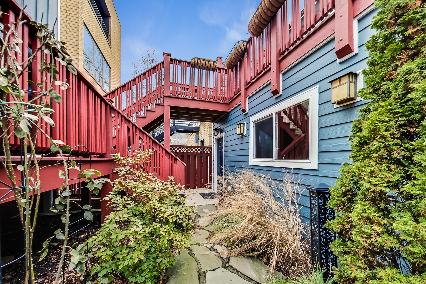 1508 West School Street Chicago, IL 60657 - Photo 37 of 40 a view of a house with many windows and plants