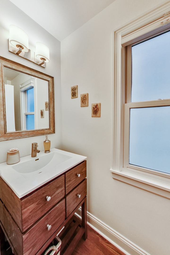 1508 West School Street Chicago, IL 60657 - Photo 5 of 40 a bathroom with a sink and a mirror