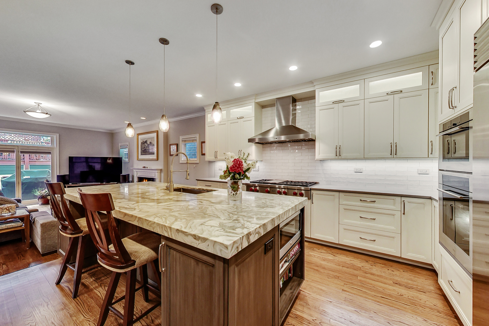 1508 West School Street Chicago, IL 60657 - Photo 6 of 40 a kitchen with stainless steel appliances granite countertop a stove top oven a sink dishwasher and a refrigerator with wooden floor