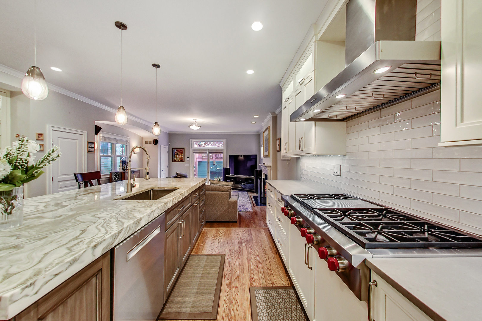 1508 West School Street Chicago, IL 60657 - Photo 7 of 40 a kitchen with stainless steel appliances granite countertop a stove and a sink