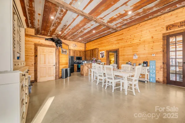 a dining room with furniture a chandelier and wooden floor