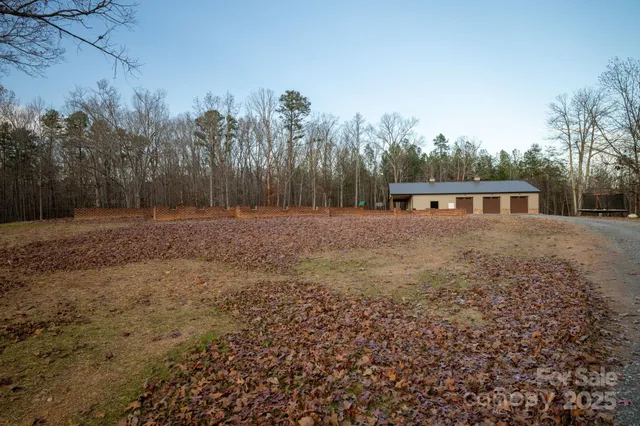 a view of a house with a yard and tree s