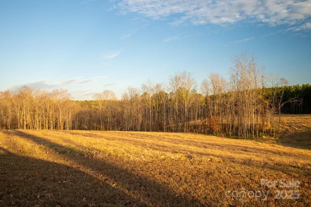 a view of large space with a house in the background