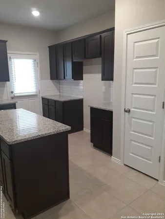 a kitchen with a stove and a refrigerator