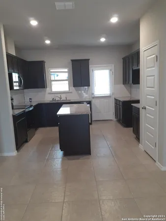 a large kitchen with a cabinets and a counter top space