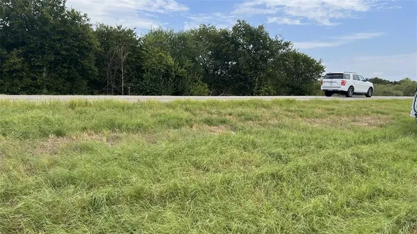 a view of a lake with a yard