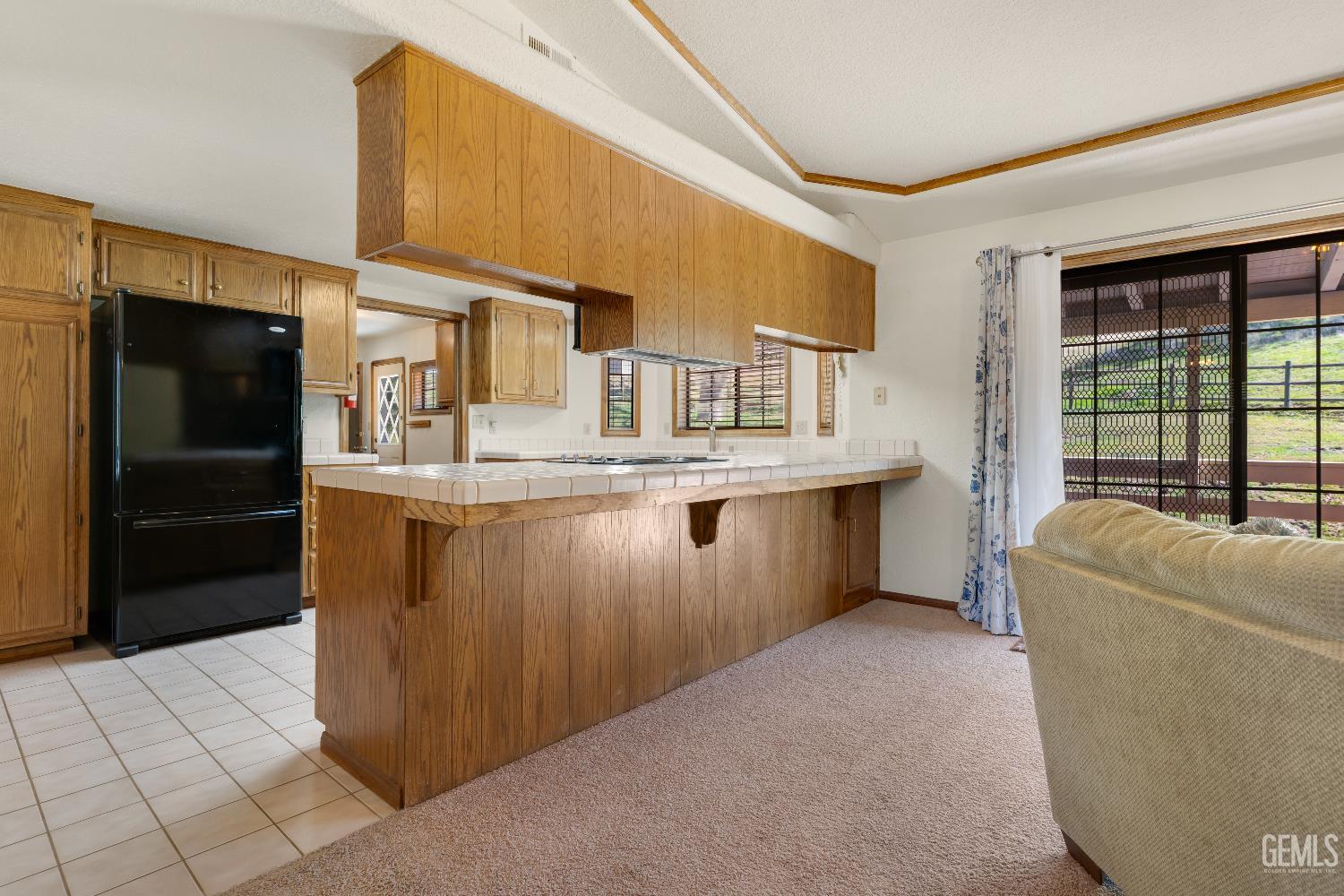Undisclosed Address Tehachapi, CA 93561 - Photo 15 of 37 a kitchen with kitchen island granite countertop a refrigerator and a stove
