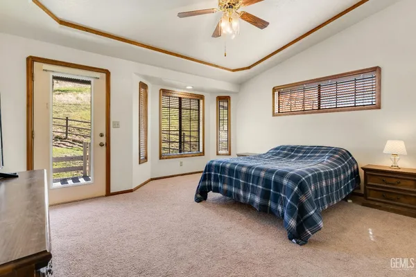 a view of an empty room with window and hardwood floor