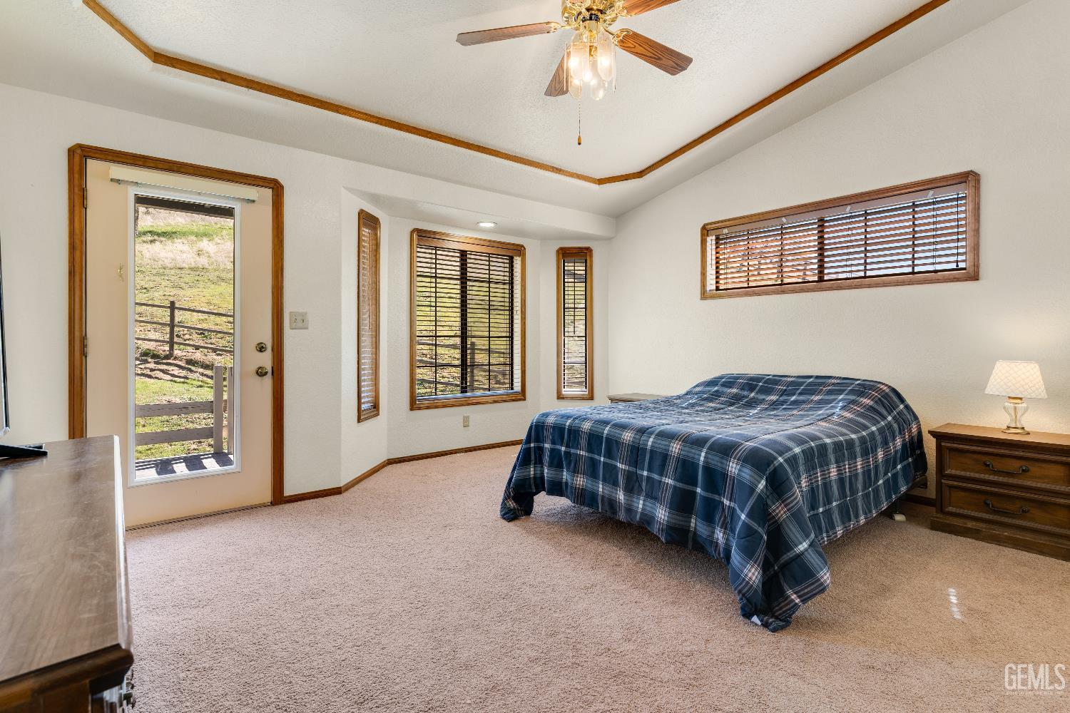 Undisclosed Address Tehachapi, CA 93561 - Photo 16 of 37 a spacious bedroom with a bed a dresser and a chandelier
