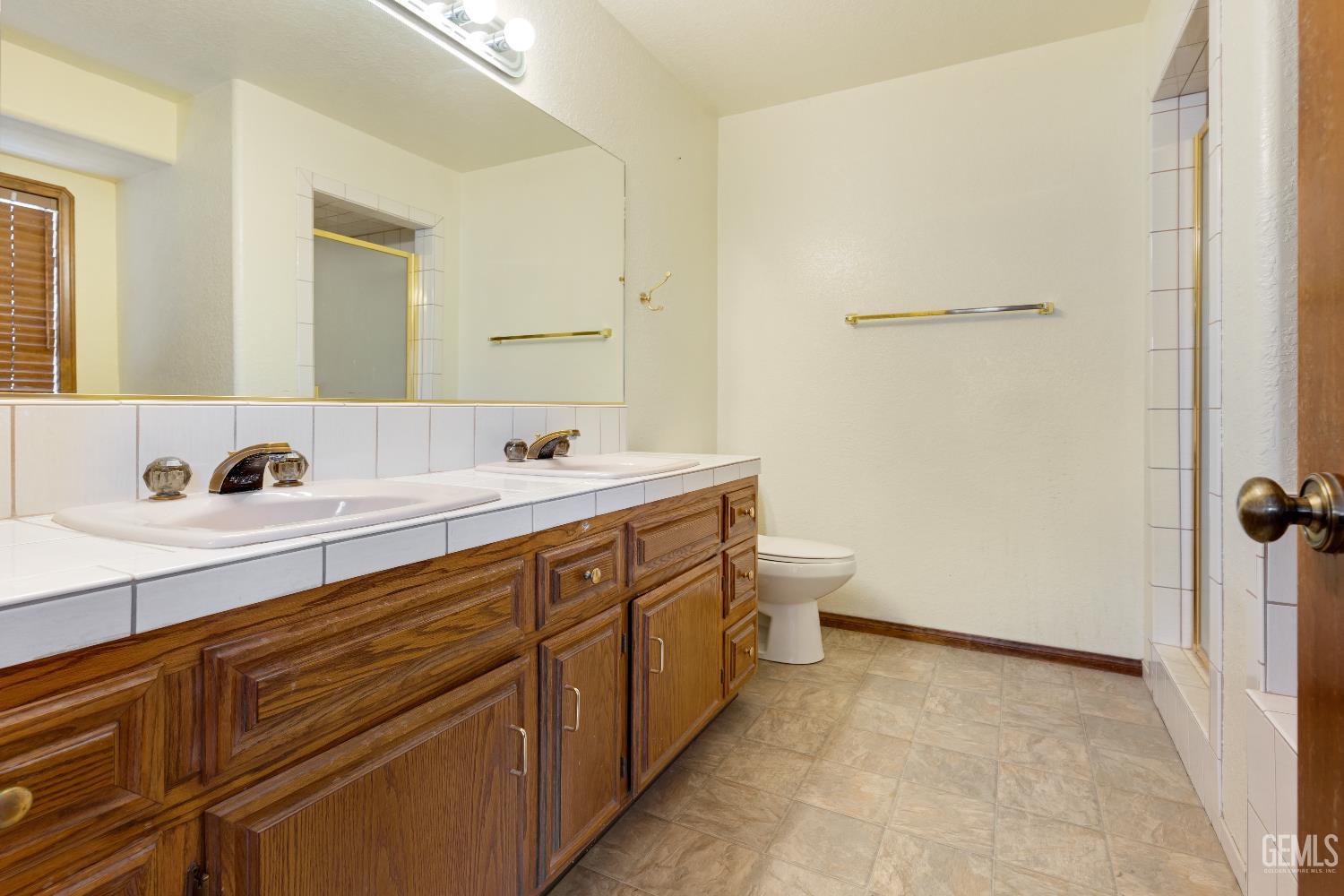 Undisclosed Address Tehachapi, CA 93561 - Photo 18 of 37 a spacious bathroom with a double vanity sink mirror and toilet