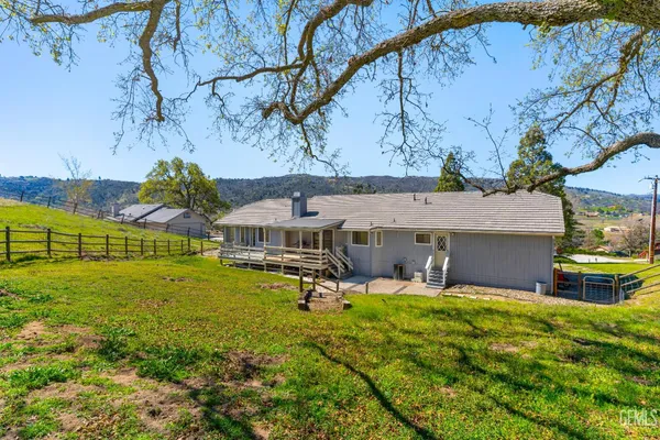 an aerial view of a house with swimming pool garden and patio