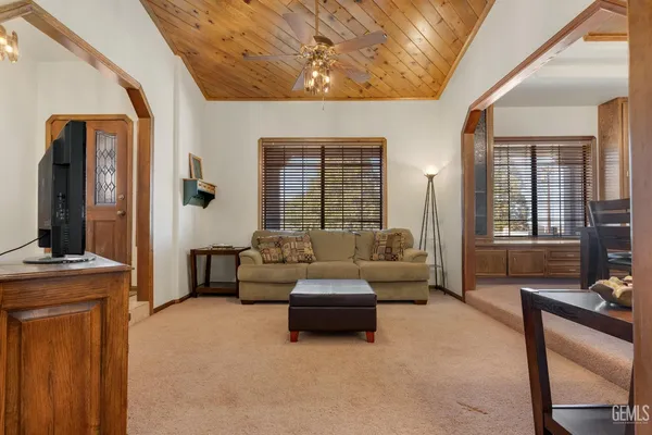 a view of a dining room with furniture and a chandelier