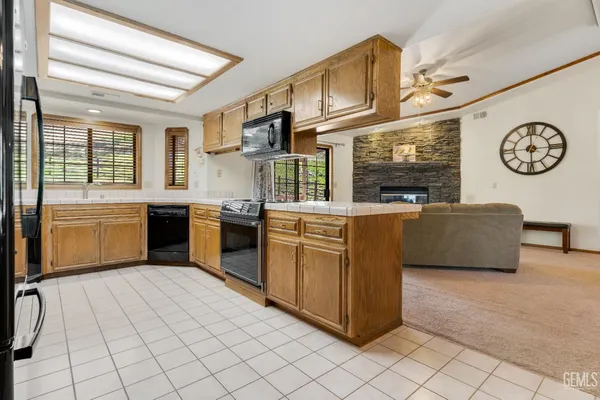 a kitchen with stainless steel appliances granite countertop a stove and a microwave
