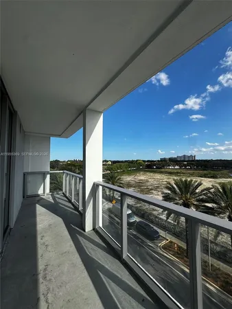 a view of a balcony with chairs and wooden floor
