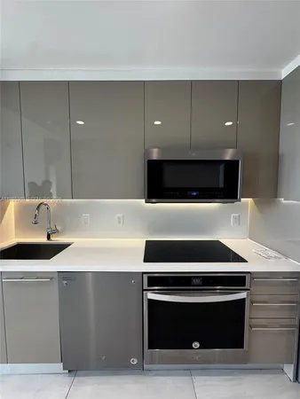 a stove top oven sitting inside of a kitchen