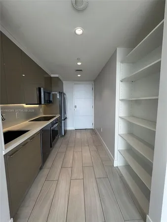 a view of a kitchen with sink and dishwasher