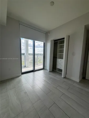 an empty room with entrance and windows