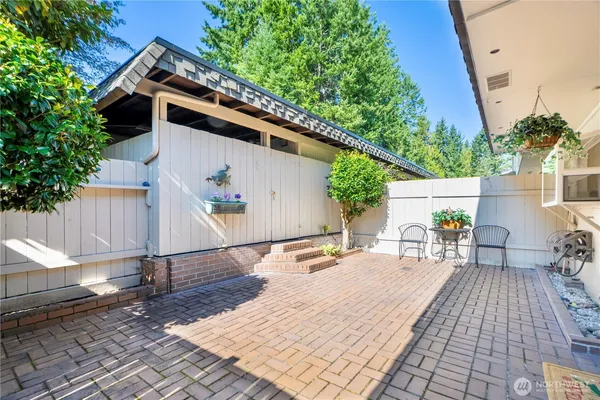 a view of a swimming pool with a patio and a yard