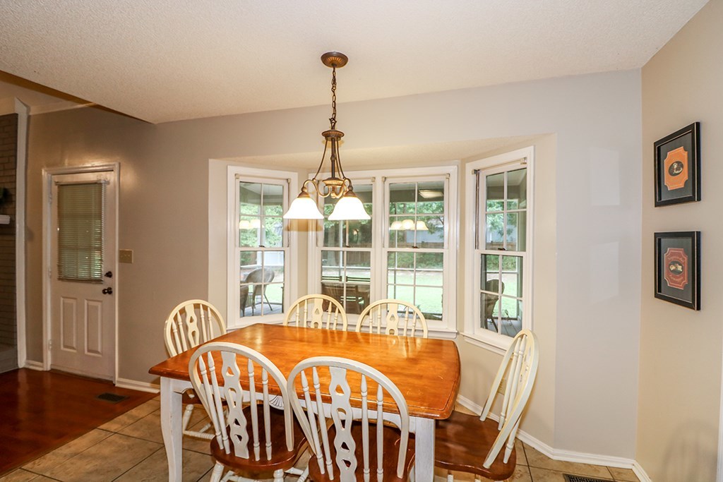 1921 Northside Road Perry, GA 31069 - Photo 14 of 49 a view of a dining room with furniture wooden floor and chandelier
